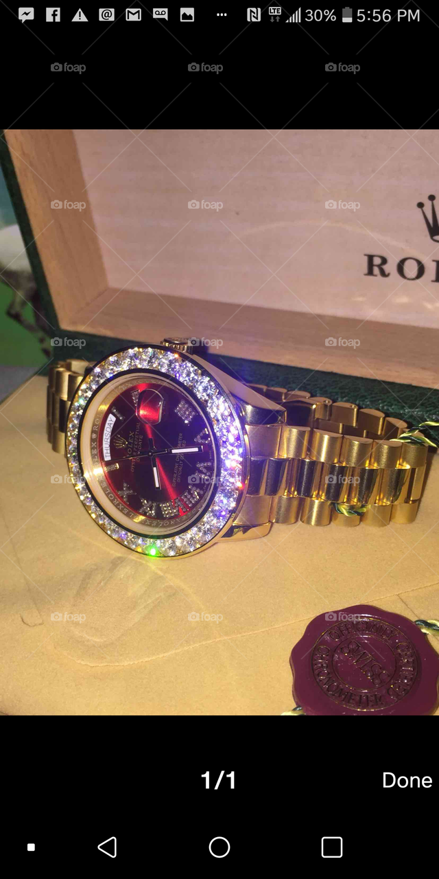 custom 18K solid gold Rolex day-date II  36 carat D color VS1 Clarity genuine diamonds. 
Specs: 
Manufacturer: Rolex
Width: 41mm
Diamonds: 36 CTW D VS1
18K Solid Gold w deep red face w diamond roman numeral markers
Msrp: $34,999 USD