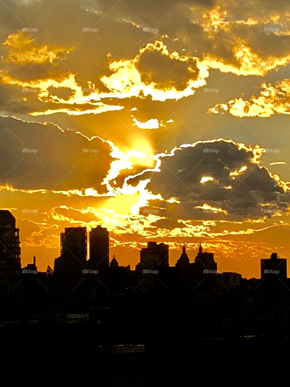 Sunsetting through clouds over Manhattan 