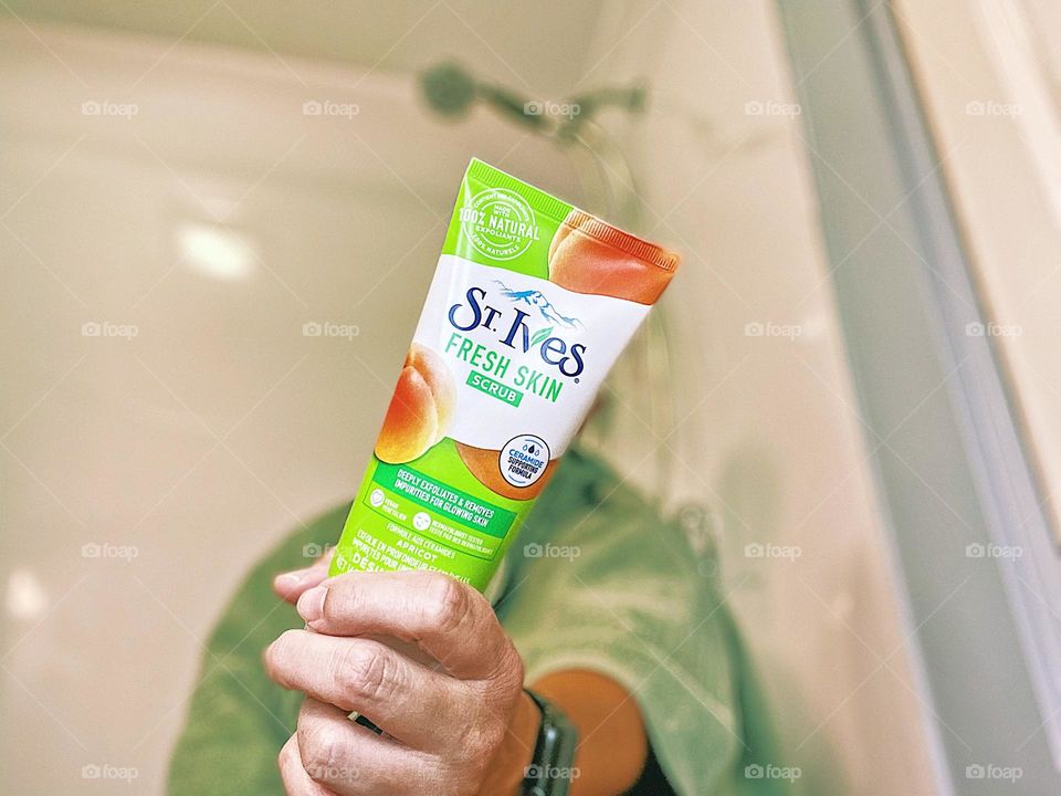 Beauty product in your hand, hand holding St. Ives product, woman holding St. Ives face scrub, St. Ives Face Scrub beauty product shot