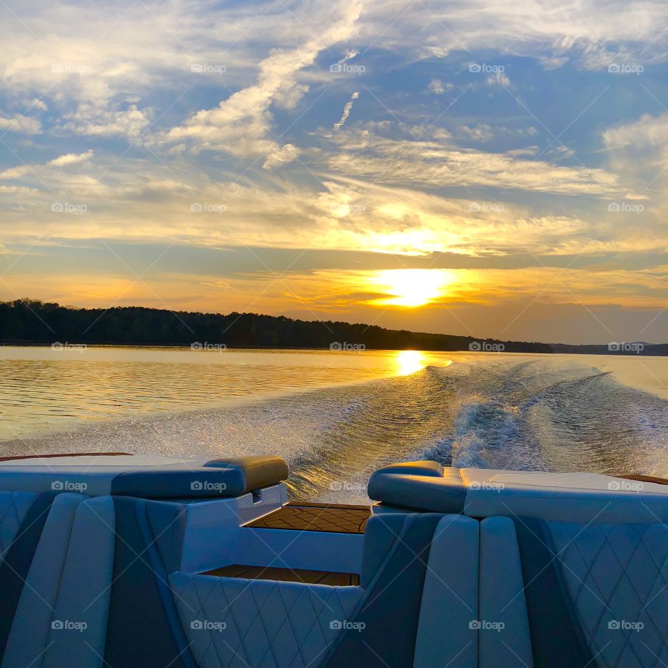 Sunset from back of the boat making waves 
