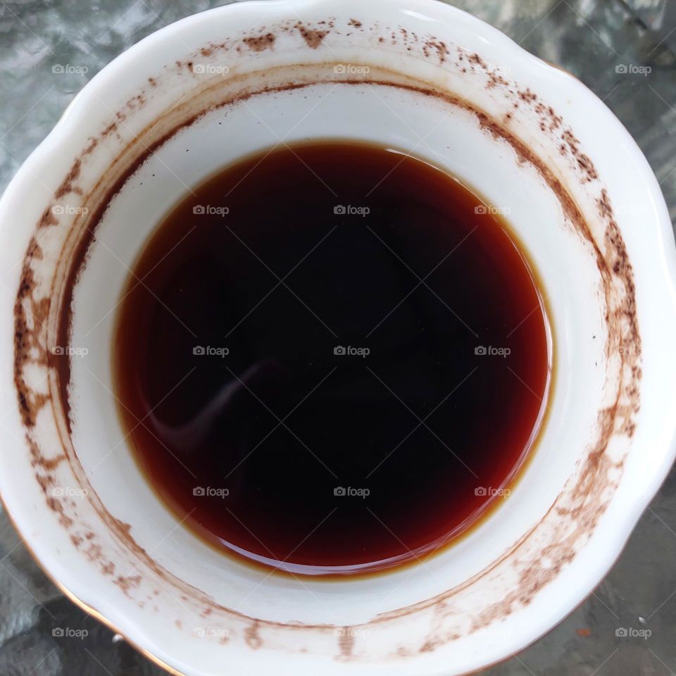 coffee in a partially drunk cup with traces of coffee on the edge of the cup