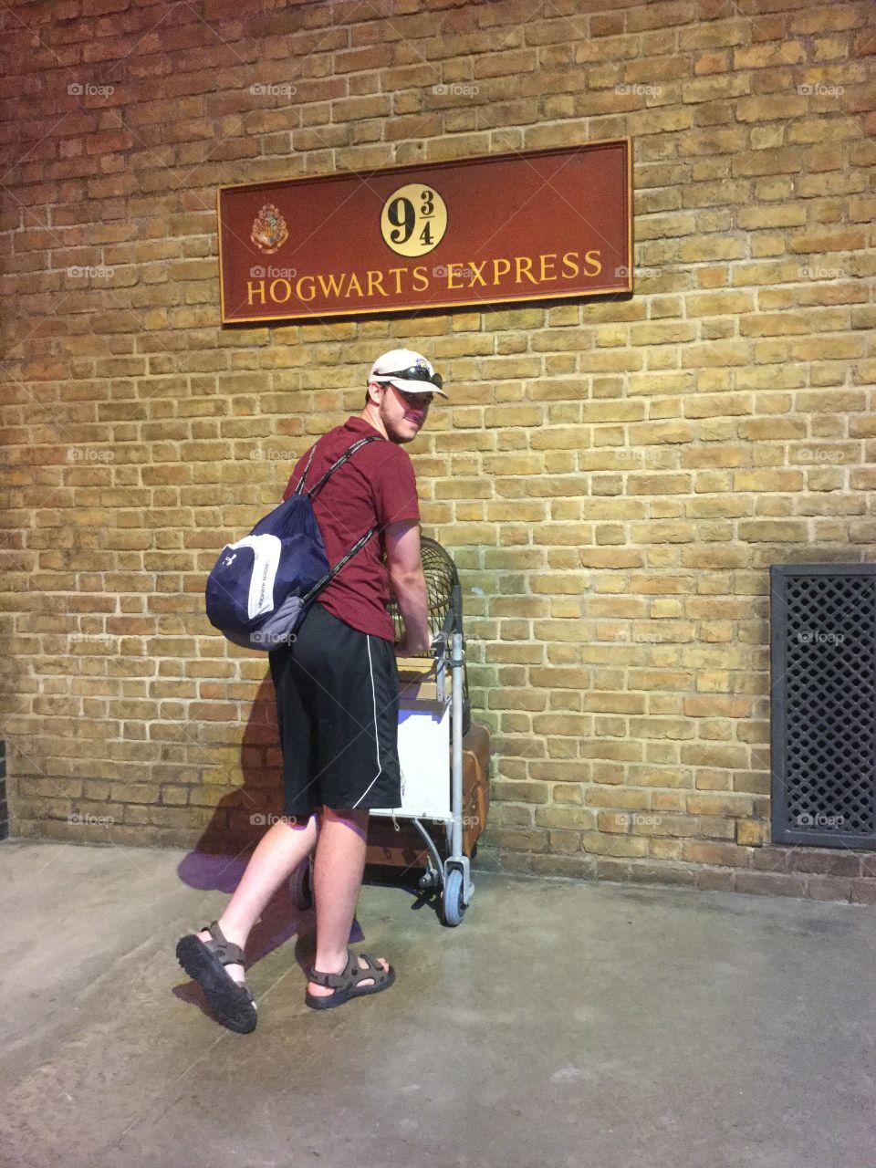 Pushing cart to Platform 9 3/4 inside Warner Brothers Studios.
