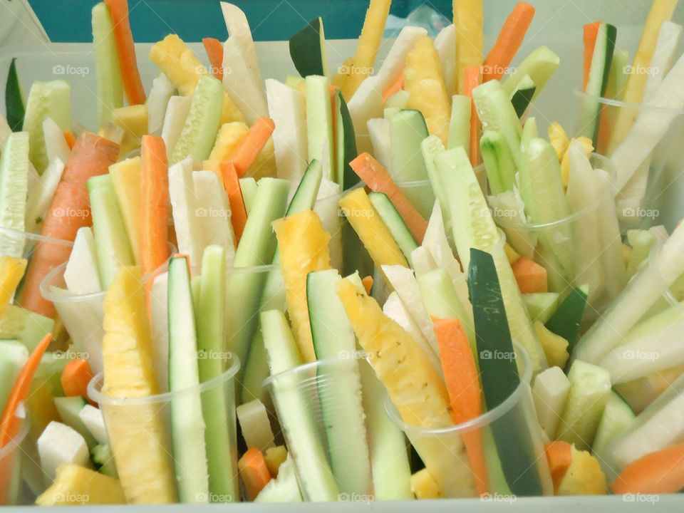 healthy snacks. delicious mix of fruits and vegetables: carrots, cucumber, celery, pineapple and jicama