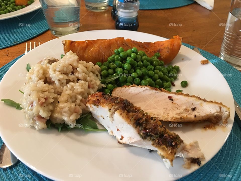 Mushroom risotto over arugula (rocket) and grilled chicken breast, with maple syrup glazed butternut squash pumpkin, and minted peas sides