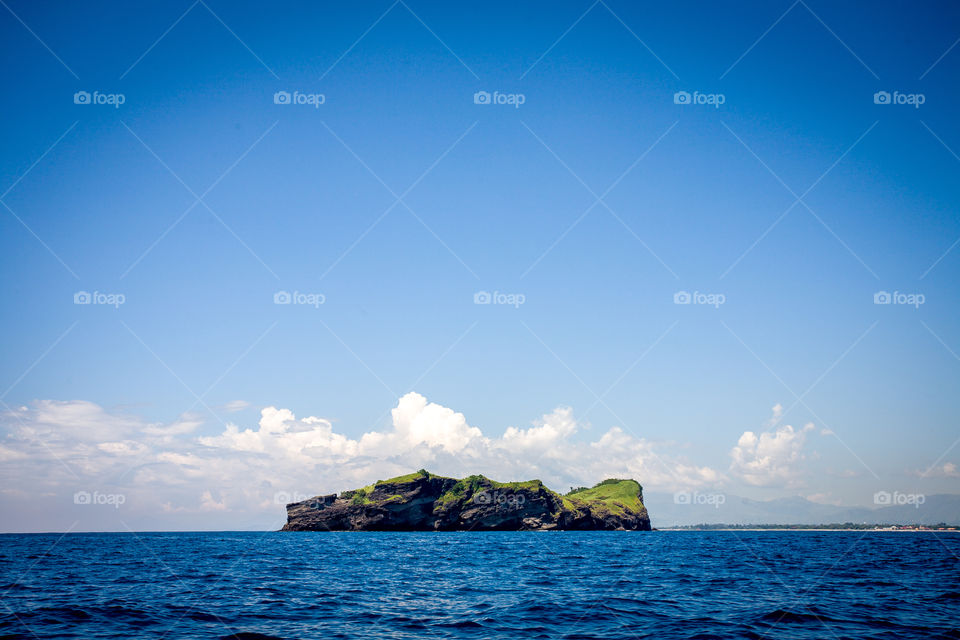 Scenic view of cliff at island