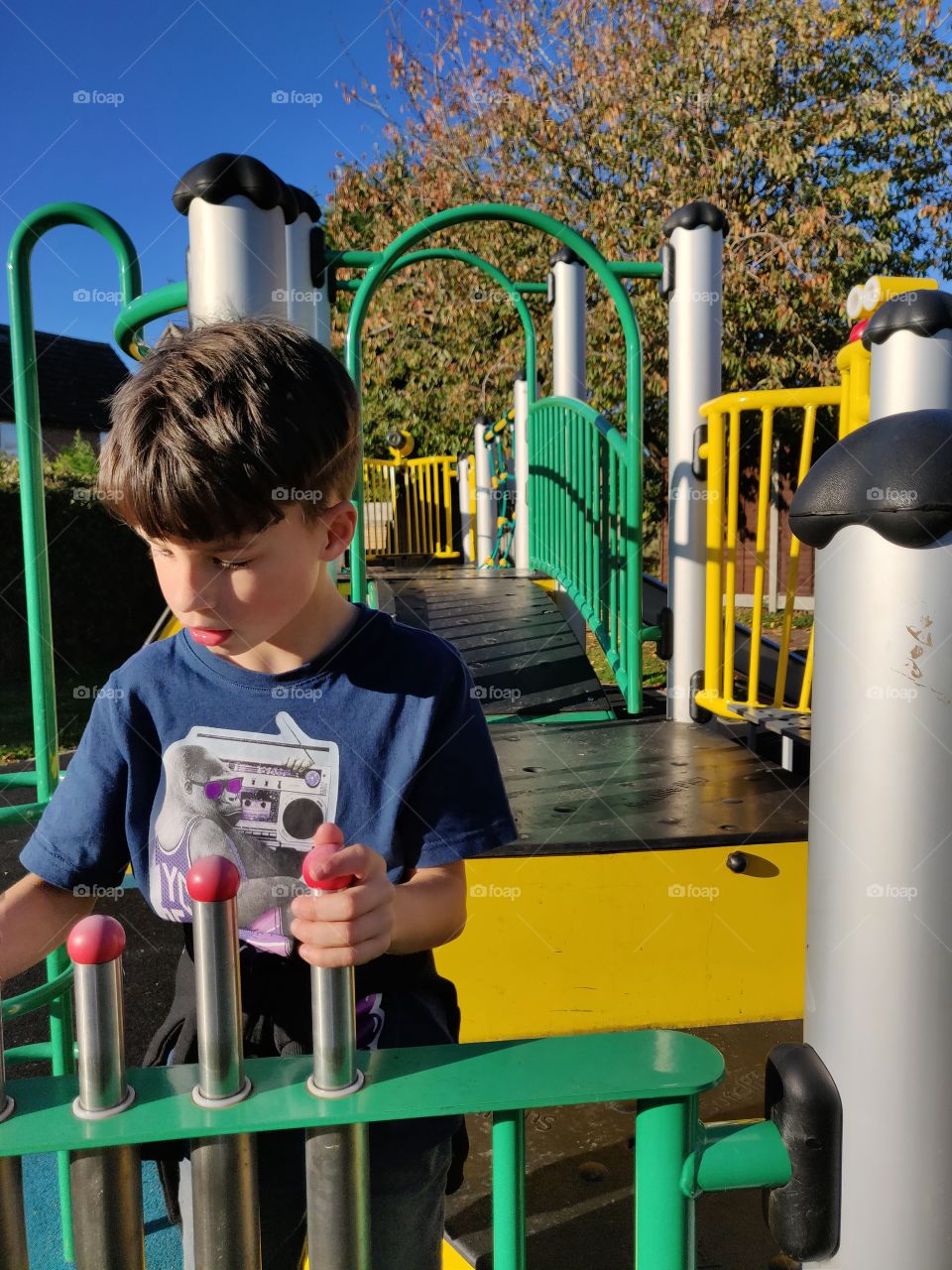 Boy playing with playground equipment