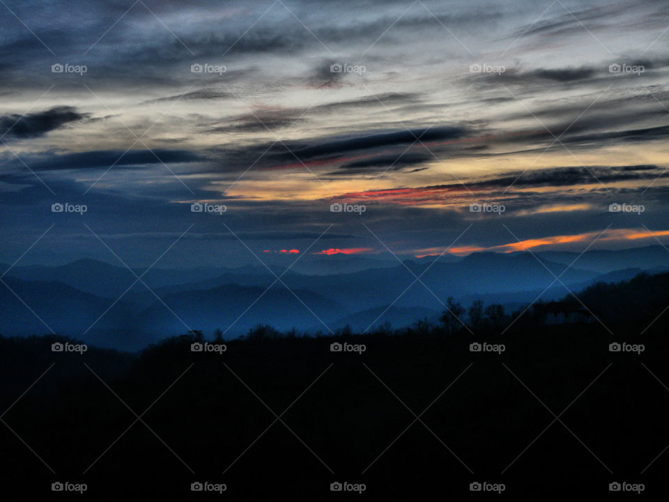 Silhouette of mountains during sunrise