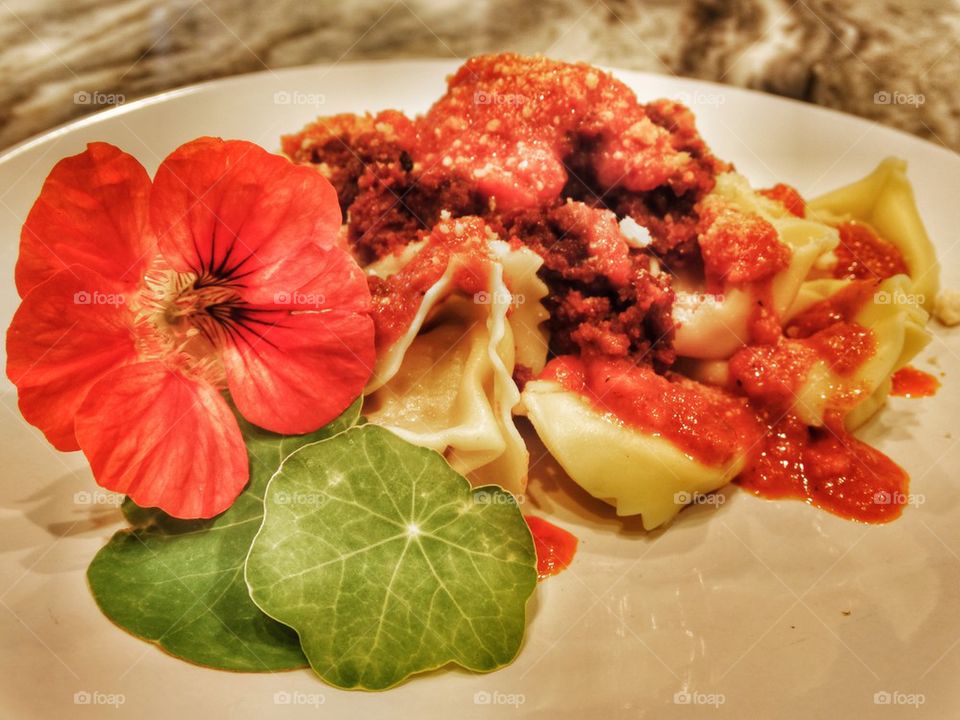 Tuscan Pork Sausage Tortellini With Nasturtium Flower Garnish. Sausage Tortellini With Wildflower Garnish
