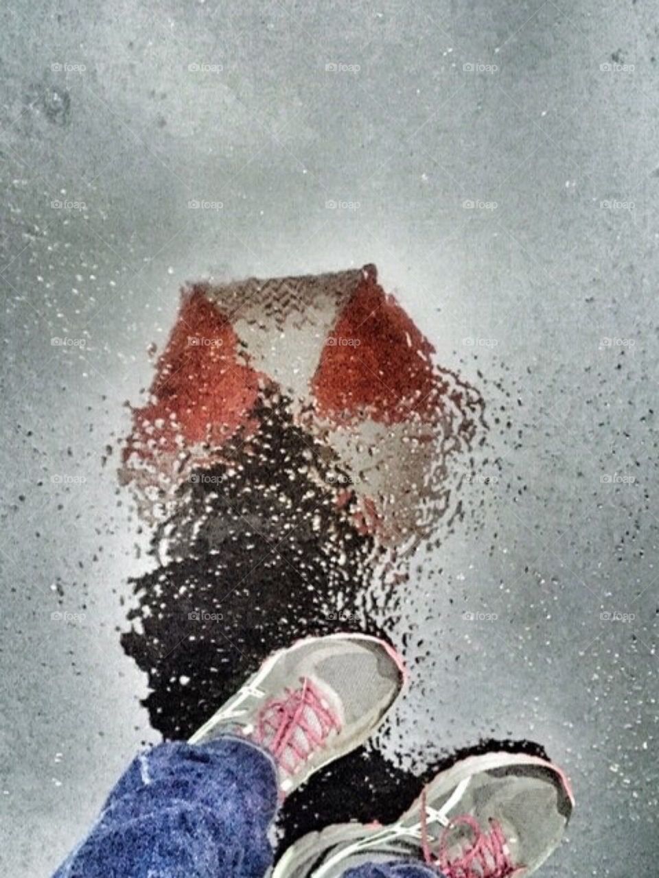 My reflection on the wet pavement