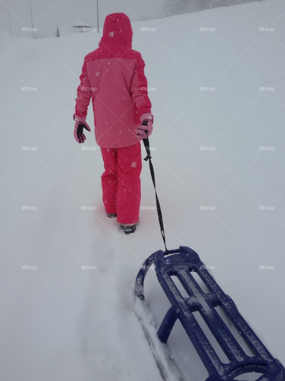 little girl with a snow sledge
