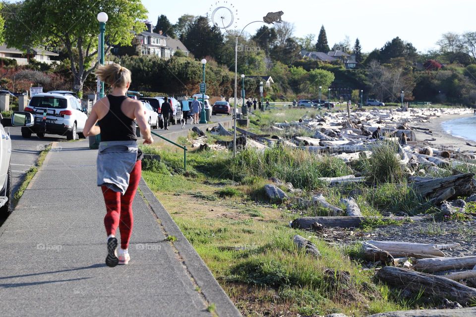 Woman running on a sidewalk 