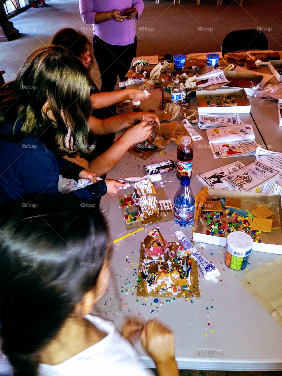 kids making gingerbread houses