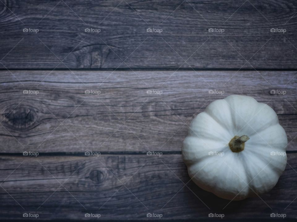 White pumpkin on a wooden board