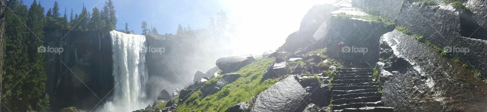We quest up the steps. Steps carved out of age old stone. To our left is a roaring waterfall, with rainbows at the bottom. To our right is a solid wall of rock, looming overhead. The mist obscure the view around the next bend. I feel as though I've entered another world.