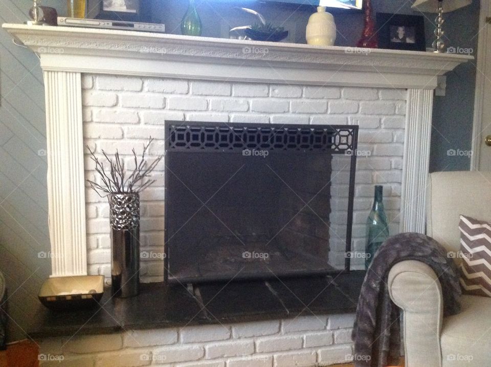 A brick fireplace painted white for a more modern feel.