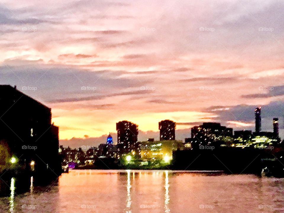 An impression in pastel pink seen from aboard our sailboat “Salvation” looking out onto the waters of the East River at Newtown Creek in Long Island City, Queens, NY photographed on an early evening in December 2021. Hypnotic Productions