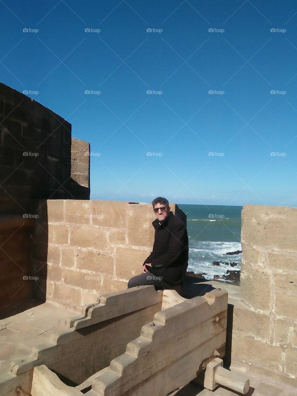 Im sitting on the wall against the sea at essaouira city in Morocco