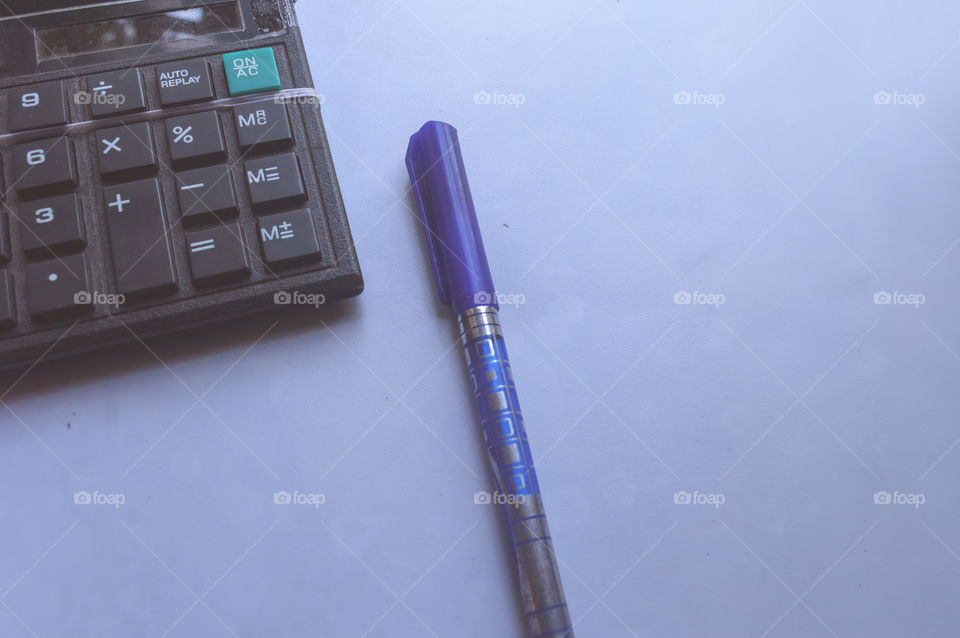 pen and calculator or calculating machine on white background. Financial accounting work and Business concept. Useful to show economy report, profit calculation, tax information, business growth plan