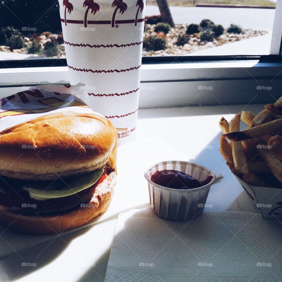 IN-N-OUT. Flattened beef in between some bread with seasoned potato sticks. ;)