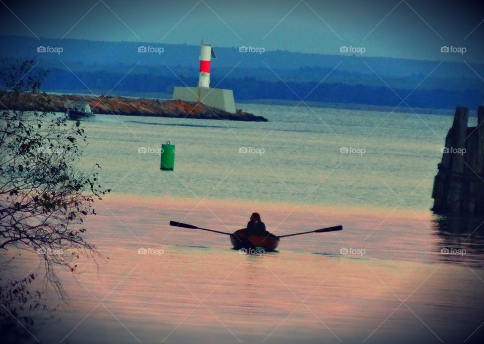 Beautiful colors and a silhouette of a person rowing a boat