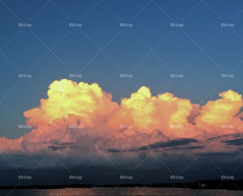 South West Florida Sunset . The sun setting on some storm clouds over the water