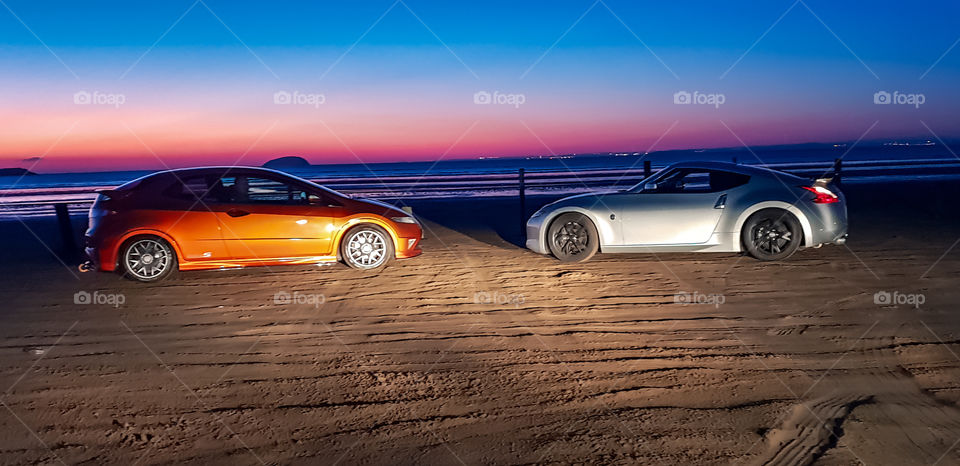 Nissan 370z & Honda civic on the beach with sunset