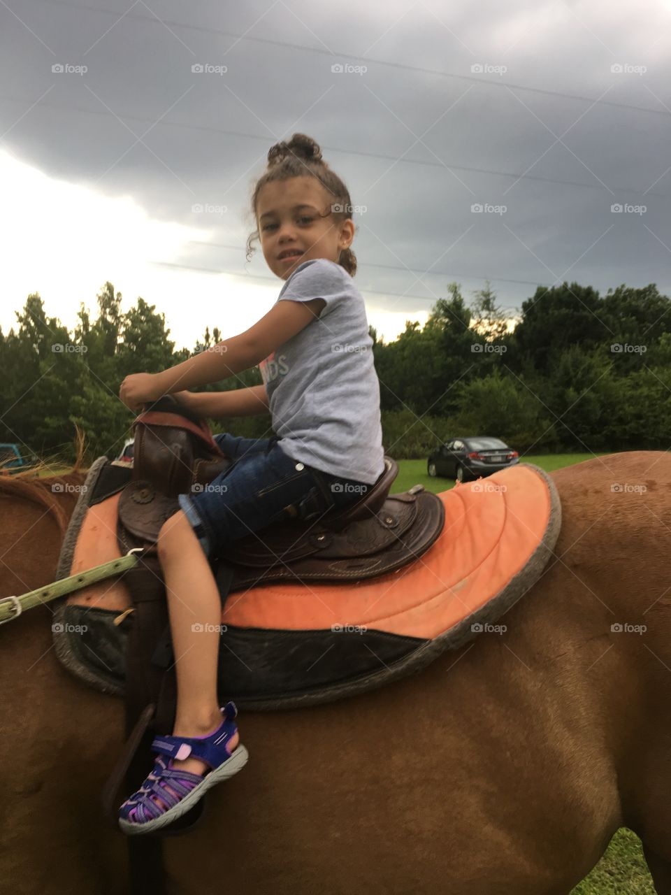 Young girl Horseback riding on a cool evening 