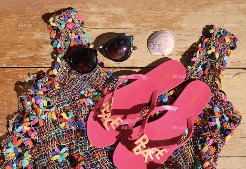 My Melissas, sunglasses and a colorful summer dress on a bench. 