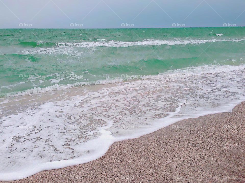 Beautiful ocean waves on a sandy beach.