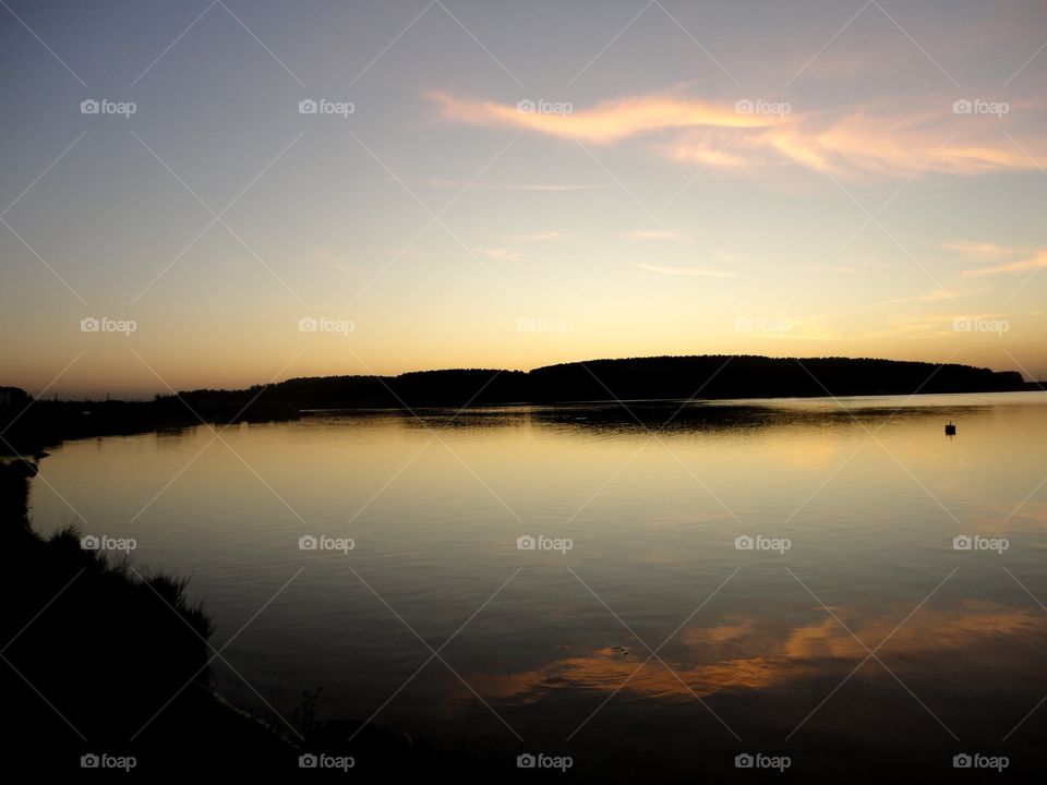 forest and lake shore beautiful sunset landscape and reflection