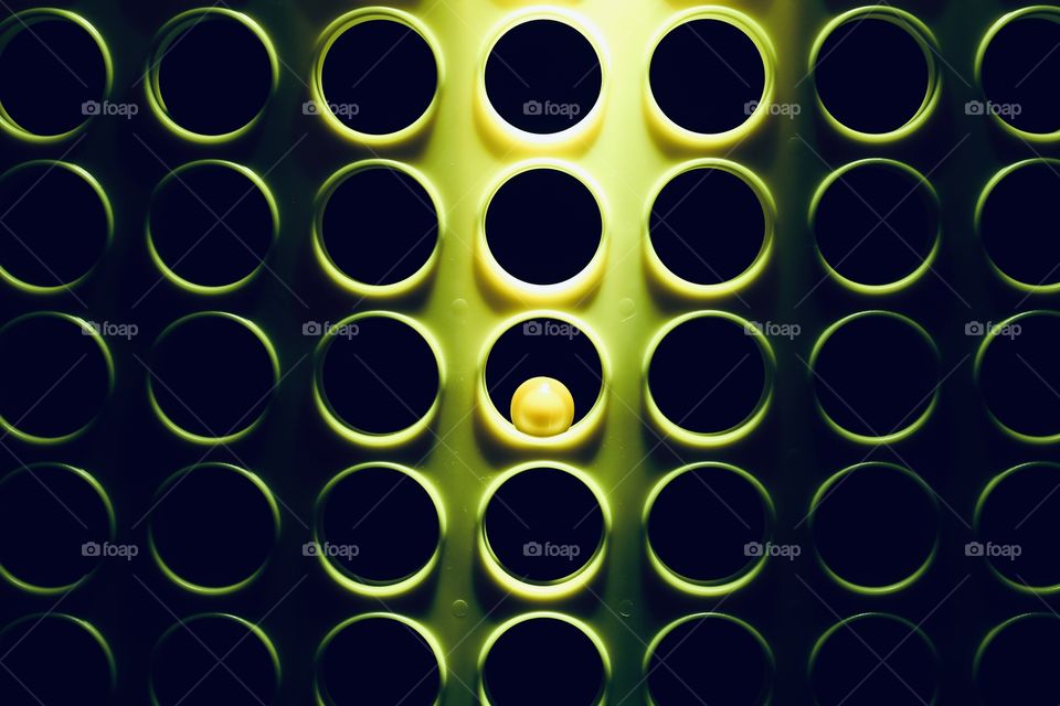 Lowlight closeup shot of holes and a marble