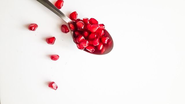 A spoon of pomegranate seeds
