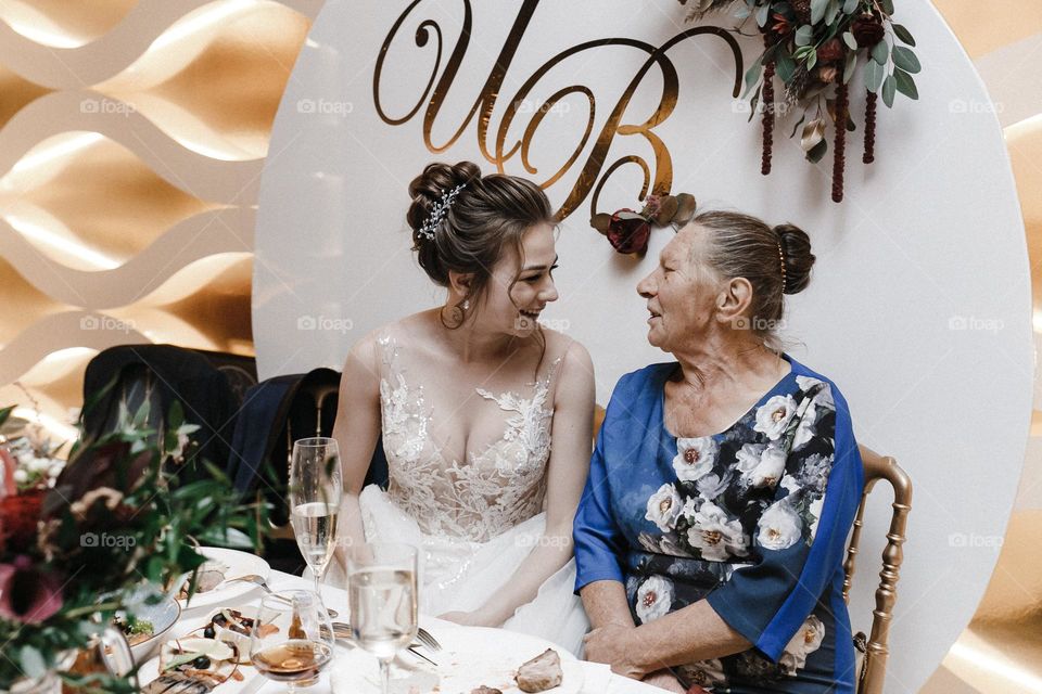 Granddaughter and grandmother. Bride and grandmother on wedding party