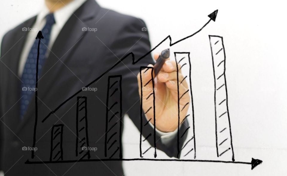 Business man pointing on growing chart of analysis business 