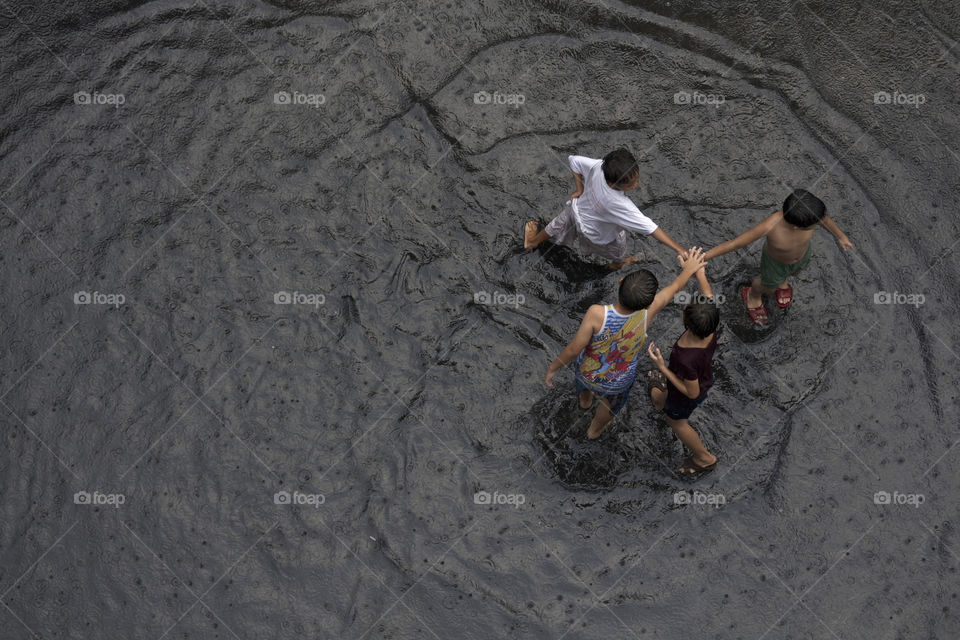 Kids playing under the rain