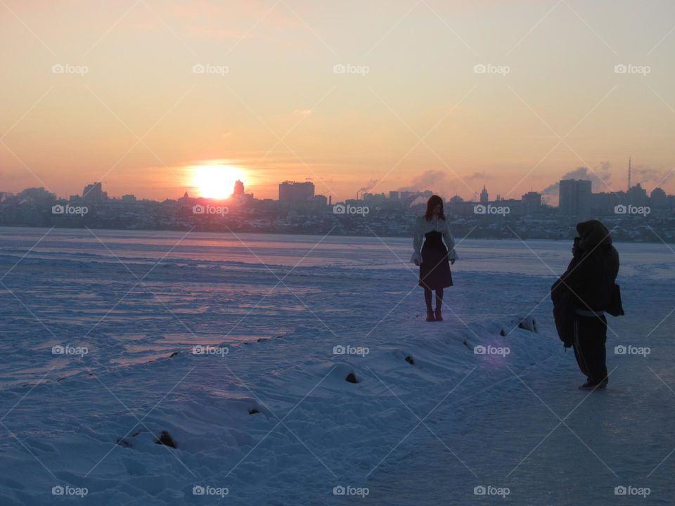 sunset, sky at sunset, clouds full of the sky, winter, snow and cold, city on the other side