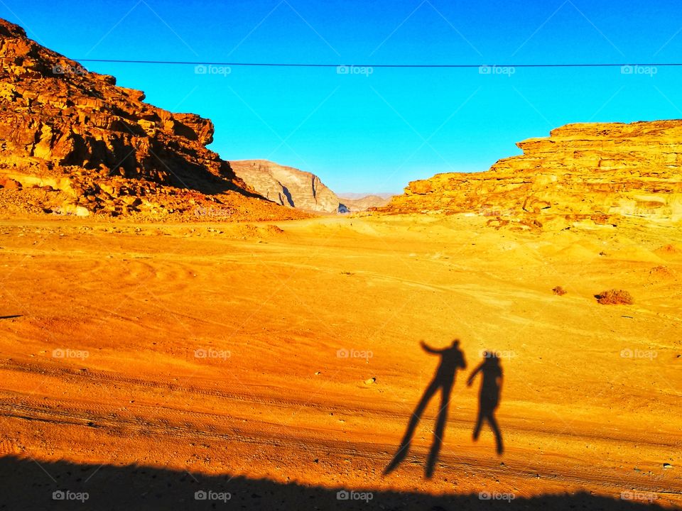 Jumping at sunset in the desert of Jordan