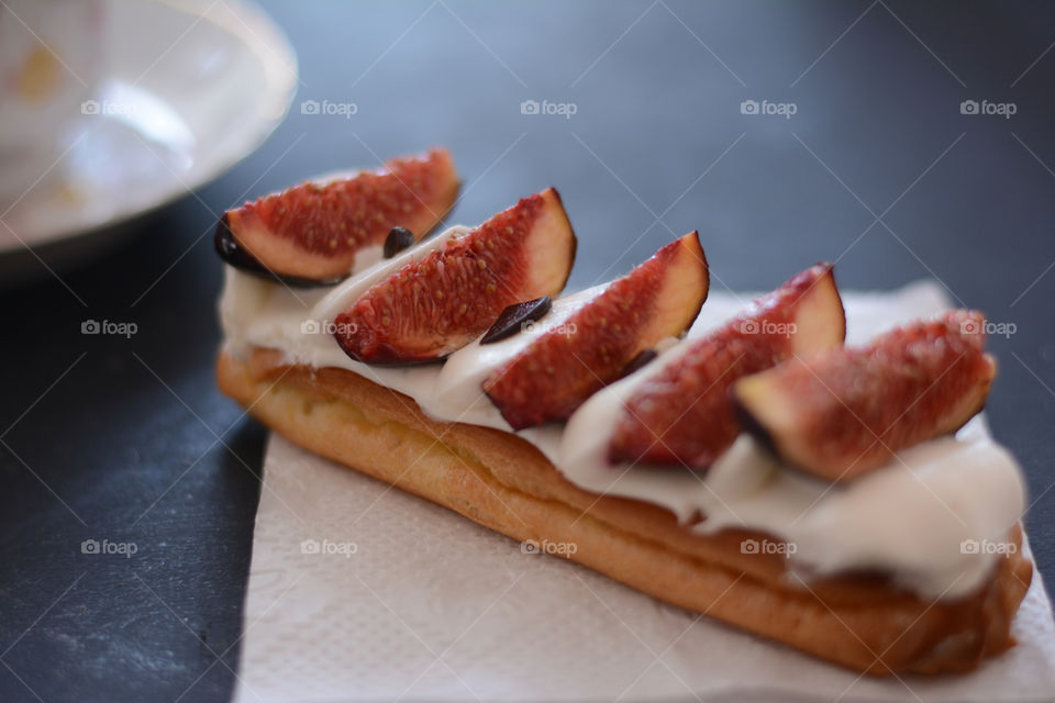 French eclair with berries on the table
