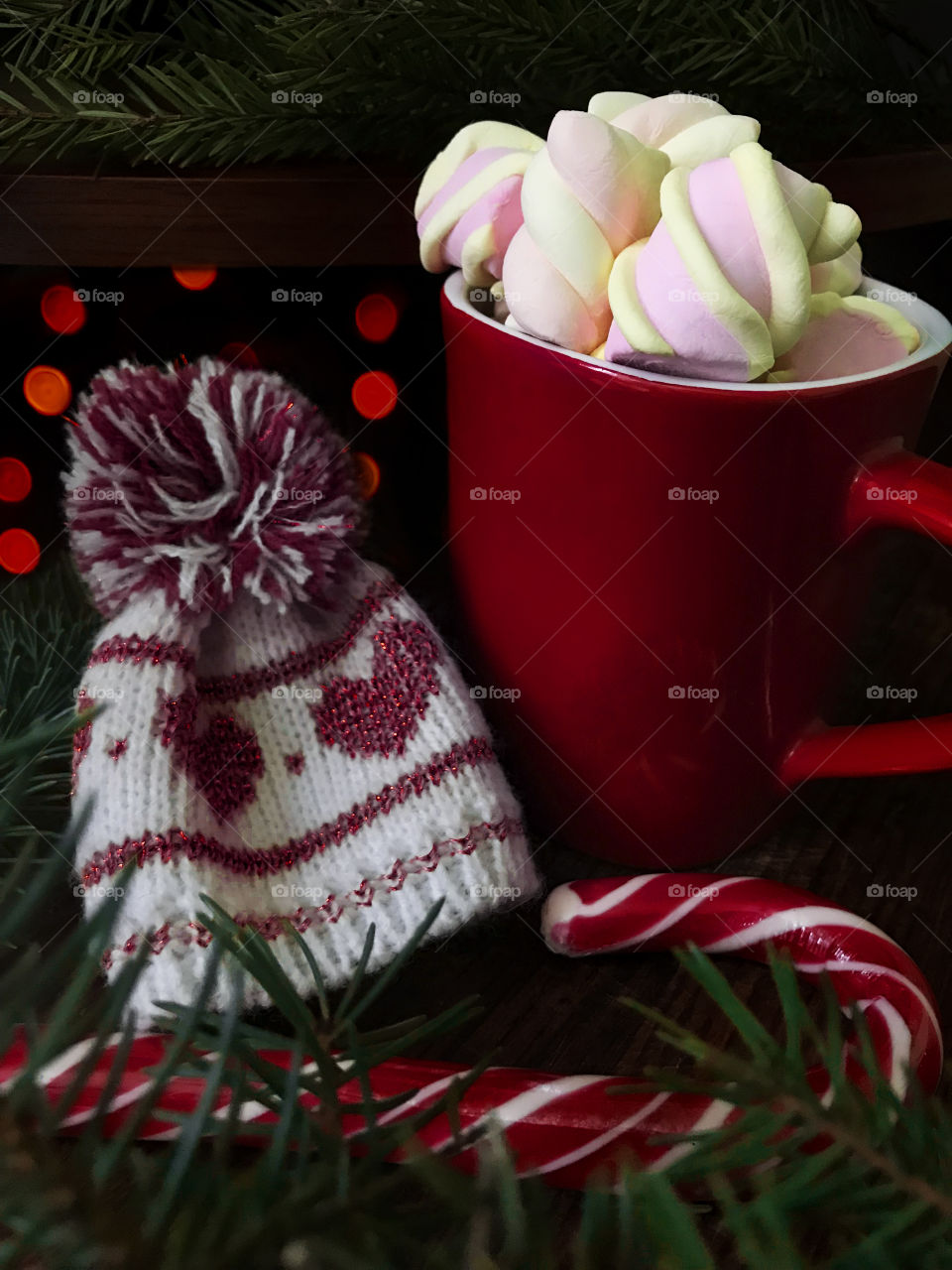 Red cup with hot coffee and colorful marshmallows 