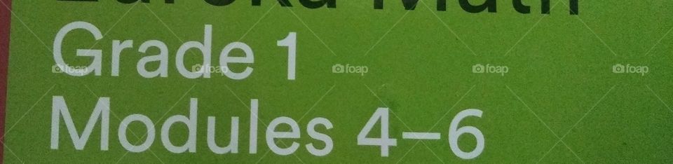 Green and white letters and numbers on a book 📚.