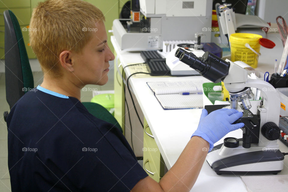 A women at work in small, private laboratory. Small business, medicine.