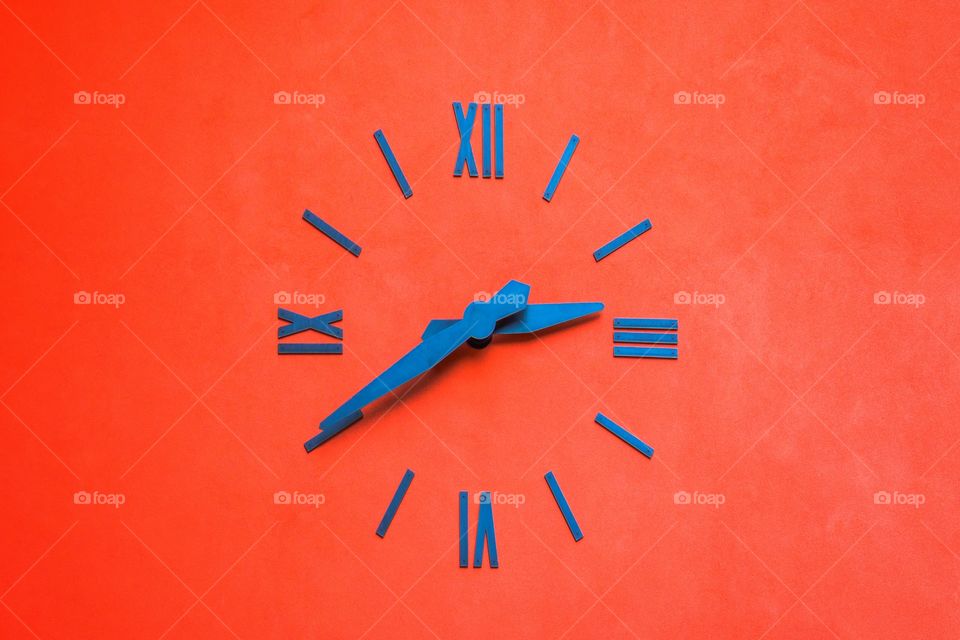 Blue clock on orange background