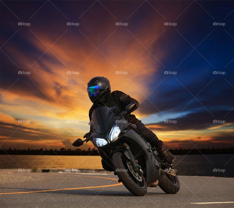 biker riding into sunset