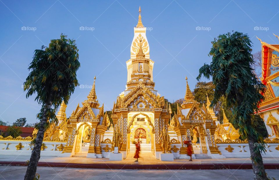 Beautiful golden temple with two monks in Thailand