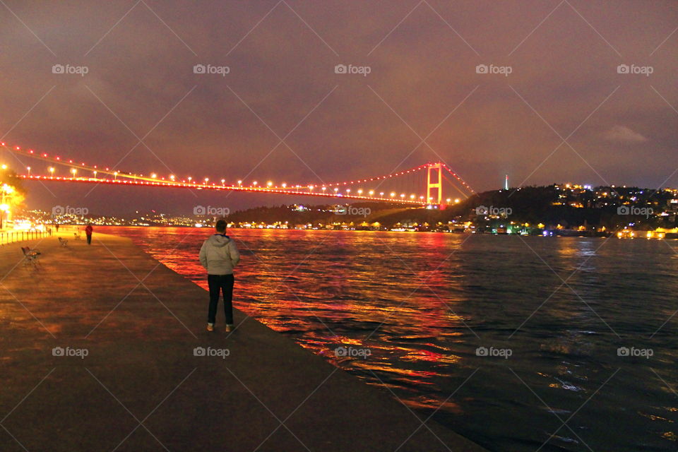 A beautiful bridge in Istanbul Turkey. A picture of the lights from a bridge in Istanbul reflecting in the Bosphorus Strait in Istanbul Turkey 