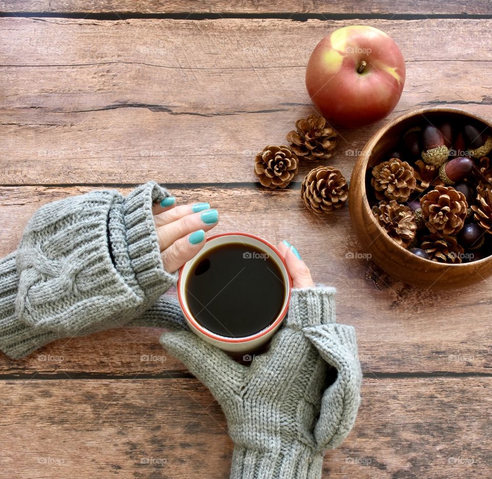 Sweater weather, hands in gloves holding a cup of coffee