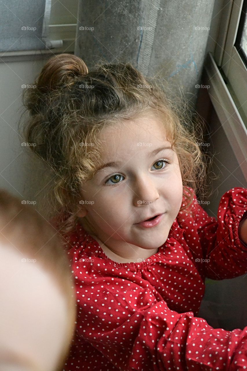 Cute girl standing near window