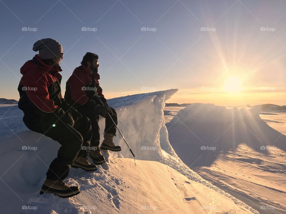 Polar men watching sunset at Antarctica