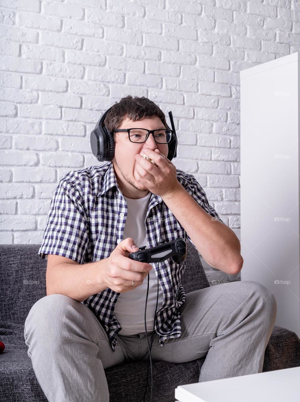 young emotional man playing video games