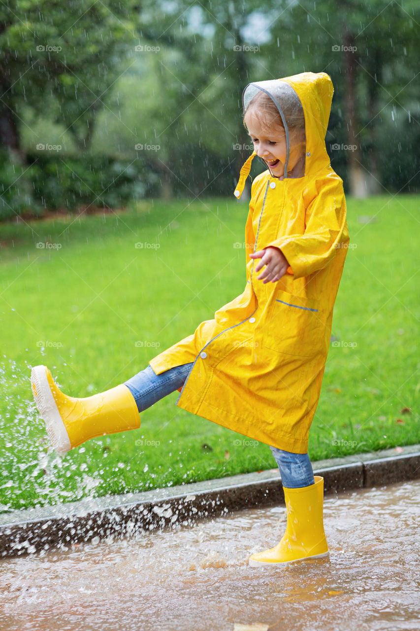 Little girl playing in puddles 